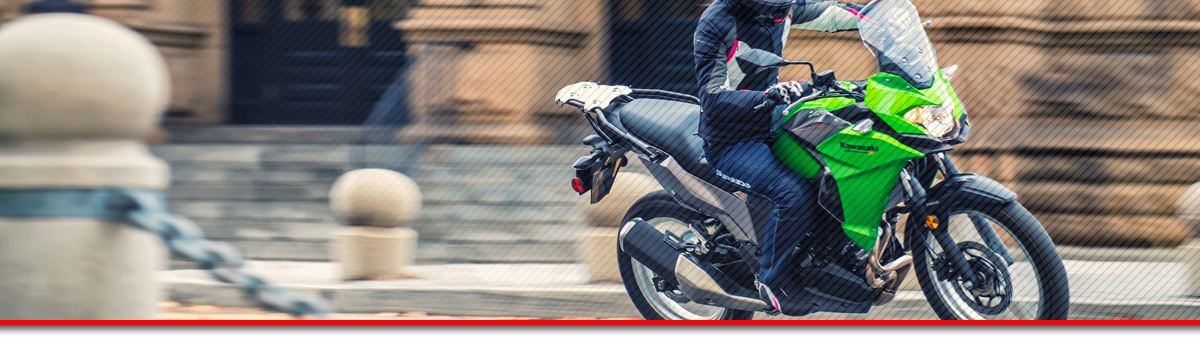 2017 Kawasaki Ninja® 300 ABS Motorcycle turning a corner through city